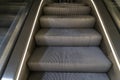 Close-up shot of empty escalator steps with a dirtproof grating Royalty Free Stock Photo