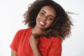 Close-up shot of energized and active positive good-looking african-american woman waking up happily starting day with