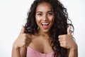 Close-up shot enthusiastic and charismatic good-looking african american girl look upbeat, show thumbs-up gesture and