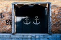 Close-up shot of an entrance to a building, framed by two large anchors