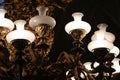 Close up shot of fancy luxurious golden royalchandelier with white light bulbs and