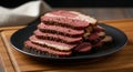 Gourmet Sliced Pastrami with Pepper Crust on Black Plate Royalty Free Stock Photo