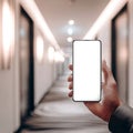 Hand Holding Blank Smartphone Screen in Modern Hotel Hallway Royalty Free Stock Photo