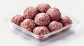 Raw Meatballs in Plastic Container on White Background Royalty Free Stock Photo