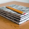 Stack of Notebooks with Pencils on Wooden Desk Royalty Free Stock Photo