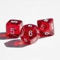 Three red dice with numbers 5 and 6 visible, casting shadows on a white surface Royalty Free Stock Photo