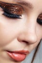 Close-up shot of female face with vogue golden shining eyes make