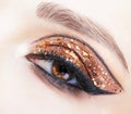 Close-up shot of female face with vogue golden shining eyes make