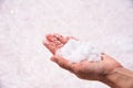 Close up shot of female hand holding heap of salt.