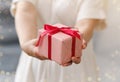 Small gift in the hands of a woman indoor. Royalty Free Stock Photo