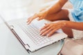 Close-up shot of female hands typing on laptop keyboard Royalty Free Stock Photo