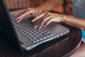 Close-up shot of female hands typing on laptop keyboard Royalty Free Stock Photo