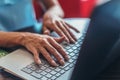 Close-up shot of female hands typing on laptop keyboard Royalty Free Stock Photo