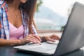 Close up shot of female hands typing on a laptop keyboard. Young woman studying and working in the park Royalty Free Stock Photo