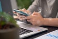 Close up shot of females hands typing on smart phone with technology icons at home office Royalty Free Stock Photo