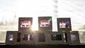 A close-up shot of film slides laid out in rows against the early morning sunlight