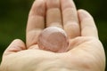Fire Quartz Sphere in Human Hand. Royalty Free Stock Photo