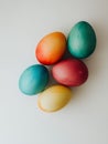 A close up shot of five colorful easter eggs arranged on a plain white surface backdrop Royalty Free Stock Photo
