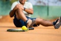 Close up shot focus on ball, senior middle aged tennis player got due to loss of tennis match or game during competition Royalty Free Stock Photo