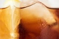 Close up shot of fragment of glass of coke with ice cubes inside Royalty Free Stock Photo