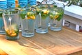 Close up shot of fresh iced lemonade in the jugs.Fresh peppermint and lemons. Summertime rest on the cafe terraces