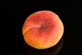 Close up shot of a fresh peach isolated on a black background Royalty Free Stock Photo