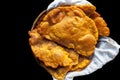 Close up shot of fresh puri Indian food in a container on a black surface. Royalty Free Stock Photo