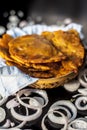 Close up shot of fresh puri Indian food in a container on a black surface. Royalty Free Stock Photo