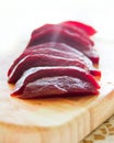 Close up shot of freshly boiled red beat on a wooden board