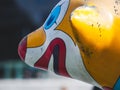 Close-up shot of a funny painted statue with a blurry background