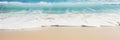 A close-up shot of gentle waves caressing the shore on a pristine sandy beach Royalty Free Stock Photo