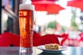 Close up shot of a glass cup of beer and a dish of fried egg Royalty Free Stock Photo