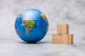 Close up shot of globe placed with wooden blocks on defocused background Royalty Free Stock Photo