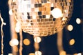 close-up shot of glossy disco ball on black background with garland Royalty Free Stock Photo