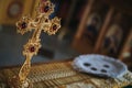 Close-up shot of a golden cross with red gemstones in the church Royalty Free Stock Photo