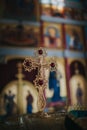 Close-up shot of a golden cross with red gemstones in the church Royalty Free Stock Photo