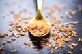 close-up shot of golden flaxseeds on a spoon