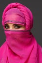 Close-up shot of a young charming woman wearing the pink hijab decorated with sequins. Arabic style. Royalty Free Stock Photo