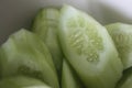 Close-up shot of green fresh cucumbers slices in the ceramic bowl. Royalty Free Stock Photo