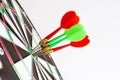 Close up shot green and red darts arrows in the target center Royalty Free Stock Photo