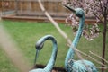 Close-up shot of green rusty decorative storks in a blur