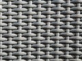 Close-up shot of the grey plastic rattan weaving of a outdoor furniture