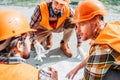 close-up shot of group of builders in hard hats having conversation