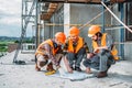 close-up shot of group of happy builders having conversation about