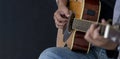 Close up shot of guitarist playing acoustic blues guitar on black background with copy space Royalty Free Stock Photo