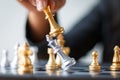 Close up shot hand of business woman moving golden chess to defeat and kill silver king chess on white and black chess board for