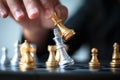 Close up shot hand of business woman moving golden chess to defeat and kill silver king chess on white and black chess board for Royalty Free Stock Photo