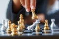 Close up shot hand of business woman moving golden chess to defeat and kill silver king chess on white and black chess board for