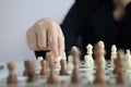 Close up shot hand of business woman playing the chess board to win by killing the king of opponent metaphor business competition