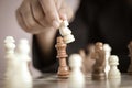 Close up shot hand of business woman playing the chess board to win by killing the king of opponent metaphor business competition